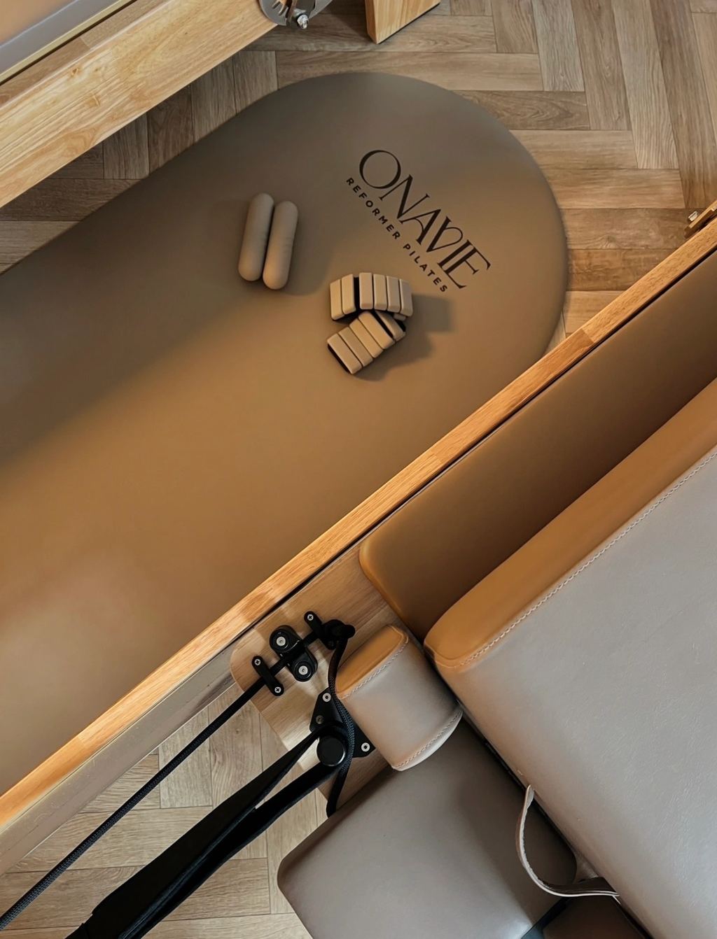 Branded Onavie Reformer Pilates mat with hand weights and soft props